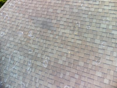 Roof with hail damage and markings from inspection hail damage markings on roof